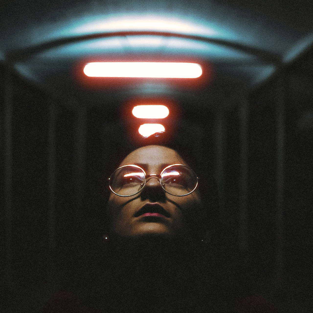 Portrait under corridor lights with FilmGrainLab film grain and halation